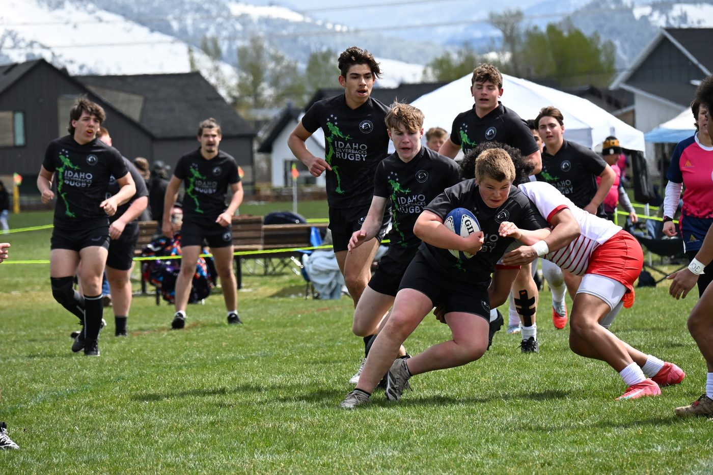 A ball carrier breaks through a tackle in open play